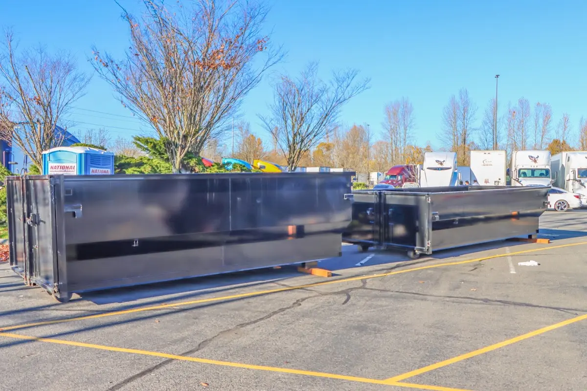 Professional dumpster rental service with roll-off container on residential driveway in Great Neck